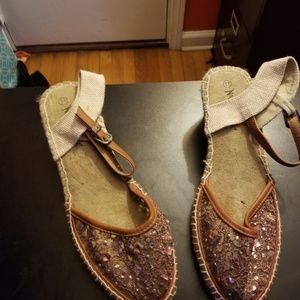 Sandals dark tank with stone on top of the shoes